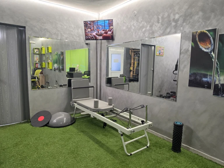 Room with a Pilates reformer, mirrors and balance equipment