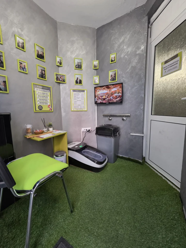 Waiting area with framed photos and the price list on the wall
