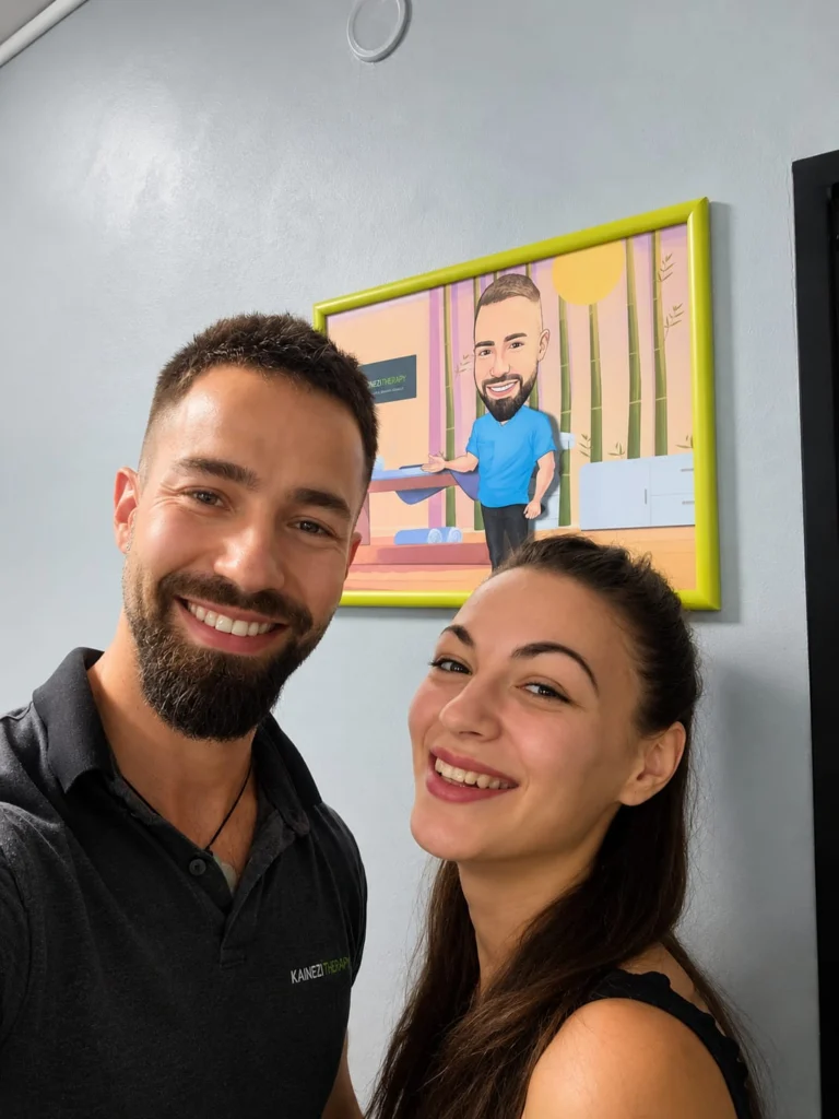 Kaloyan Zarkov and a smiling patient in front of the framed illustration at the practice